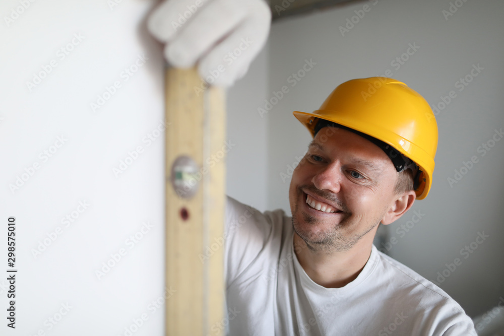 Wall mural builder holds building tool.