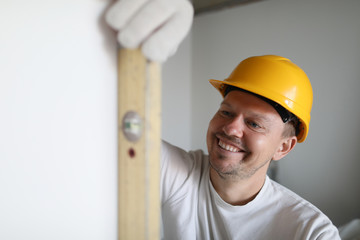 Builder holds building tool. © H_Ko