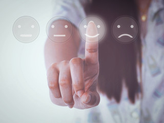 hand women pressing smile buttons on virtual touch screen 