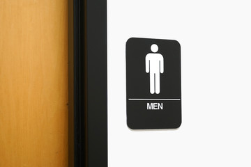 restroom sign outside restroom on the wall