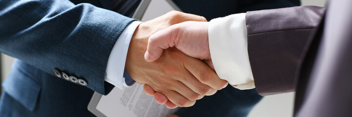 Man in suit shake hand as hello in office