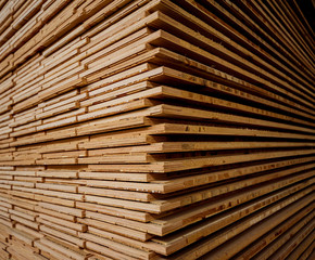 Stack of natural rough wooden boards. Wooden boards, lumber, industrial wood.