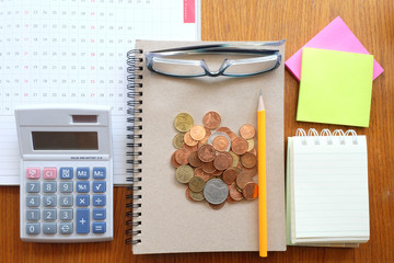 coin and planner with business concept