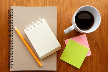 note paper and coffee on wooden table