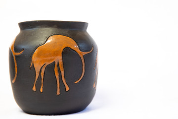 Black and brown African clay pot on an isolated white background