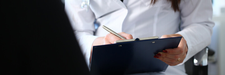 Female doctor hand hold silver pen