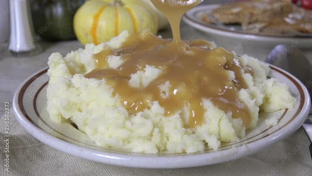 Canvas Prints Pouring turkey gravy over mashed potatoes 