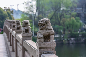 Row of lion statues on a bridge