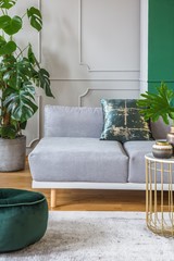 Stylish living room interior with trendy sofa with pillows, real photo