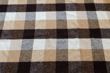 Brown checkered wool plaid fabric texture. tartan texture