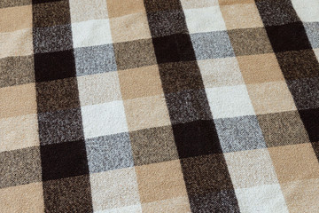 Fototapeta premium Brown checkered wool plaid fabric texture. tartan texture