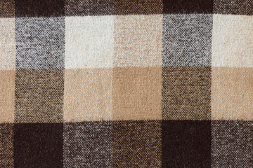 Brown checkered wool plaid fabric texture. tartan texture