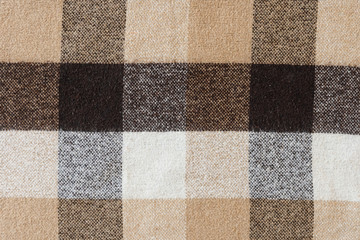 Brown checkered wool plaid fabric texture. tartan texture