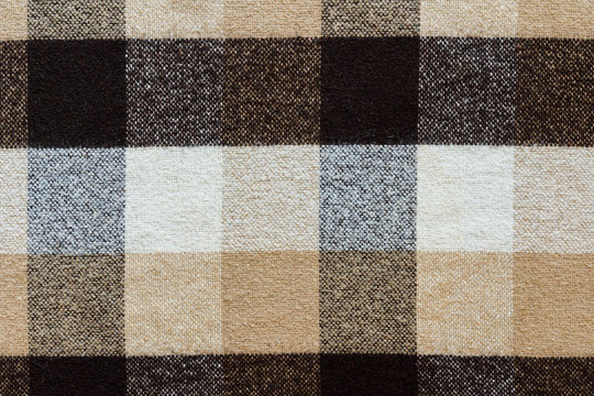 Brown checkered wool plaid fabric texture. tartan texture