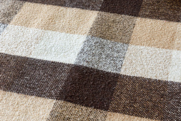 Fototapeta premium Brown checkered wool plaid fabric texture. tartan texture