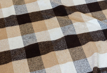Brown checkered wool plaid fabric texture. tartan texture