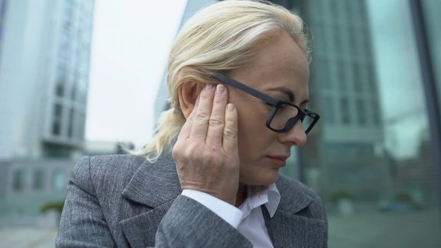 Adult business lady suffering strong ear pain, otitis symptom, spasm and health