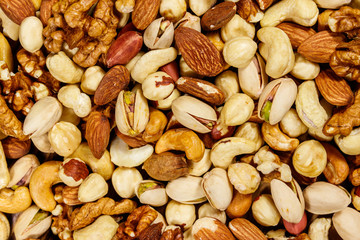 Background of mixed nuts (walnuts, pistachio, almond, peanut, cashew, hazelnut). Healthy eating concept