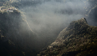 Spectacular aerial view into the Bode Gorge with rising fog in autumn. Mystical forest of the Harz...