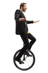 Businessman riding a unicycle © Ljupco Smokovski