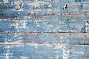 Blue colored and faded grungy wooden for background