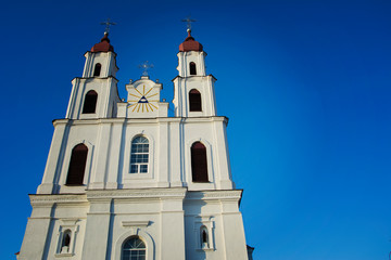 Fototapeta na wymiar Catholic Cathedral Church with Catholic crosses on the background of blue clear cloudless sky.