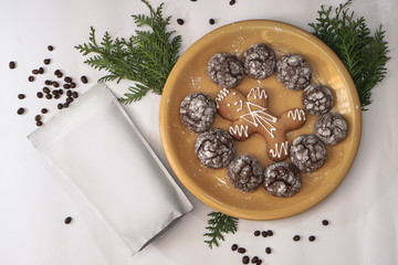 Template of ecological paper bag for storing coffee, tea on the background of ginger cookies and sweets. Vacuum packaging for christmas and new year present