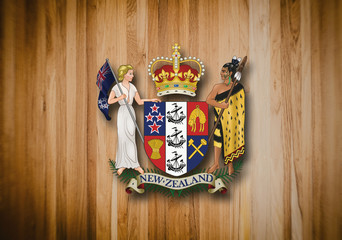 New Zealand coat of arms on wooden background.