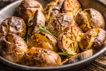 Potatoes roasted with garlic spices and herbs in vintage pan