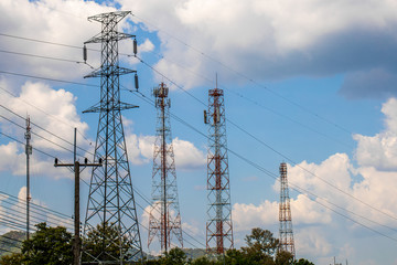 The view of hi voltage poles and wire or cables and cell phone signal with the blue sky and white clouds  background 