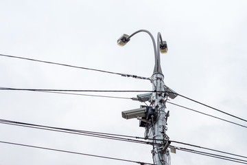 Electric pole with wires. Video cameras on the pole.