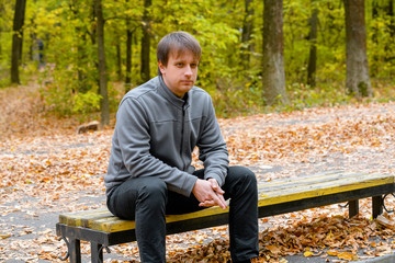 Fototapeta premium Portrait of young courageous man in autumn park
