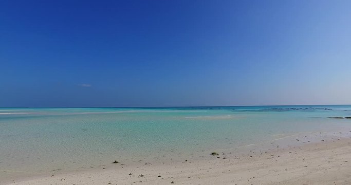 The Quite Environment of White Sand and Clear Ocean Under the Amazing Blue Sky in Indonesia  - Close-up Shot 4K