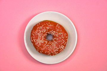 Beautiful juicy donut with a sweet cream..Cupcake on a pink background for kitchen design.