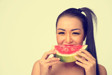 Beautiful young asian woman eatting a slice of fresh watermelon on background, Isolated.