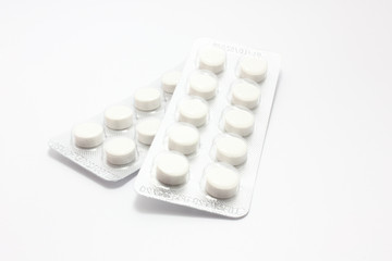 Packed pills​ isolated​ on​ white​ background.​ medicine​ table​ts, medical​ concept.