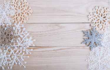 Snowflakes border on grunge wooden background. Winter holidays concept. Christmas frame