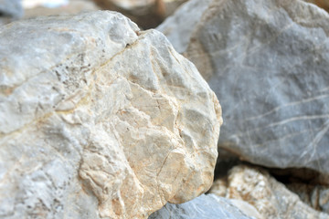 Beautiful texture of the light stone is photographed in close-up. Details of rock nature texture. A rocky ground surface.