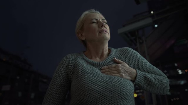 Mature Woman Touching Chest Feeling Acute Pain In Heart, Risk Of Heart Attack