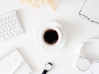 top view of office desk table with coffee cup, keyboard and notebook on white background, graphic designer, Creative Designer concept.