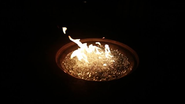 A fire burns at night in 120p super slow motion.