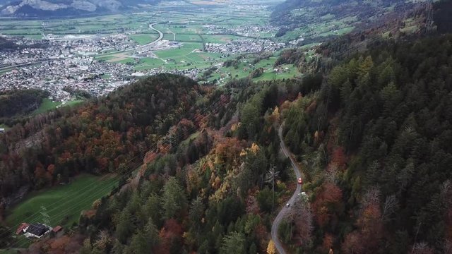 Cars drive up a narrow mountain road in Mels, Switzerland, drone clip