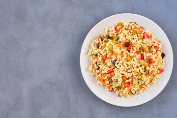 Bulgur pilaf with eggplant and vegetables. Top view with copy space	