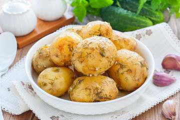 Whole baked potato with dill and garlic, horizontal