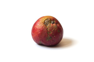 Ugly apple. Red and yellow spoiled apple isolated on a white background. Trendy ugly food concept. The problem of food waste.