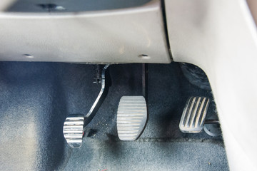 Three driving pedal with a manual transmission. Clutch, brake, accelerator of a car.