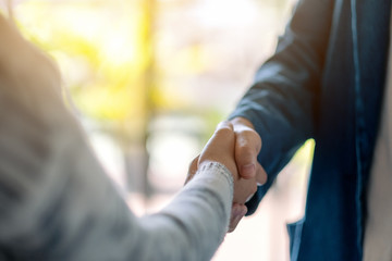 Closeup image of two people shaking hands