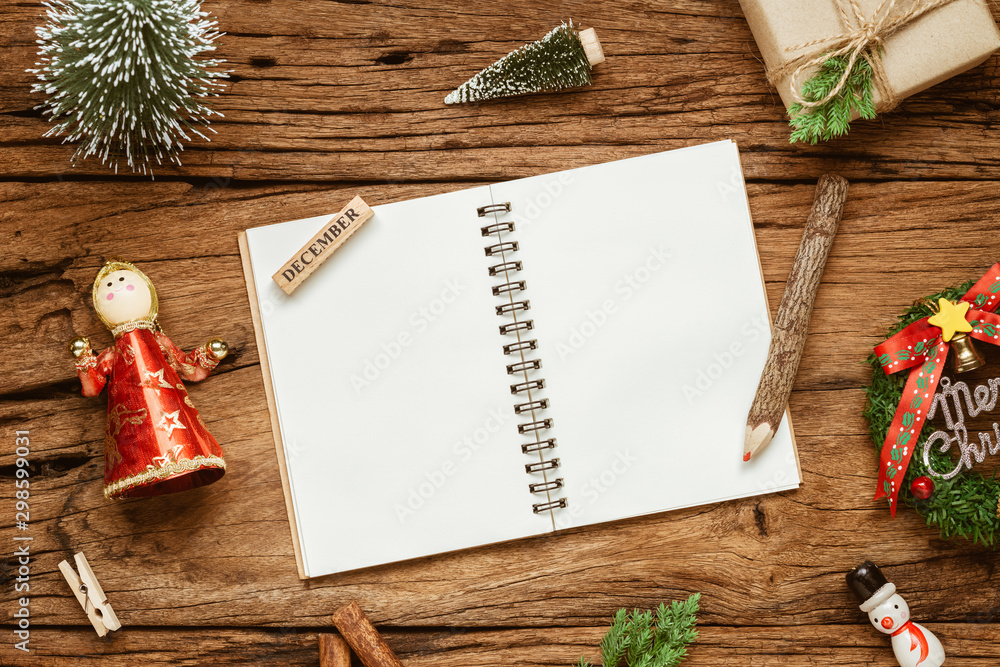 Aufkleber top view of blank notebook on grunge wood background with xmas decorations. mockup christmas backgro