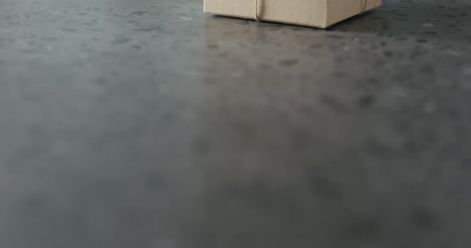 Tilt shot of brown gift box on terrazzo countertop