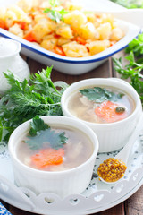 Fish aspic in portioned white bowls, selective focus